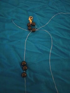 Putting the string into the next bead photos