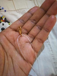 A hand holding a hook 