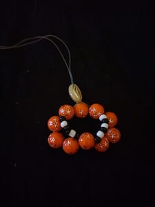 One cream bead added to the orange necklace
