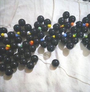 Adding one black bead to the necklace