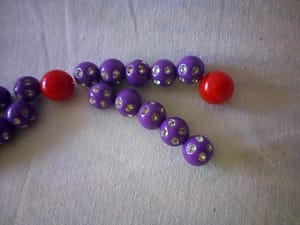 Add the red bead for our glittering bead